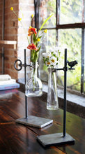 Load image into Gallery viewer, Set of 2 hanging bud vases with glass inserts in rustic metal stands featuring bird and key accents, vintage farmhouse floral display décor