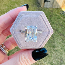 Load image into Gallery viewer, Valentina ring held in a hand against a grassy background