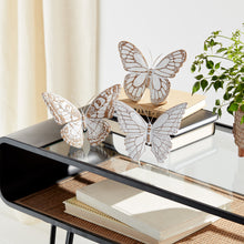 Load image into Gallery viewer, White-washed butterfly figurines with faux-wood finish and metal antennae displayed on a glass table, rustic spring farmhouse décor