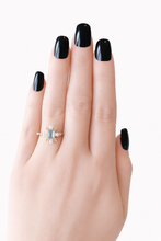 Load image into Gallery viewer, Hand with black nail polish wearing a ring on a white background