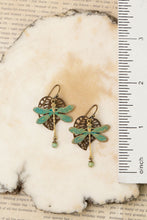 Load image into Gallery viewer, Close up of Dragonfly-earrings on a textured surface with a ruler for scale