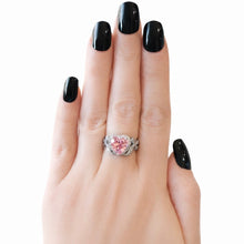 Load image into Gallery viewer, Pink heart-shaped ring on a hand with black nail polish against a white background
