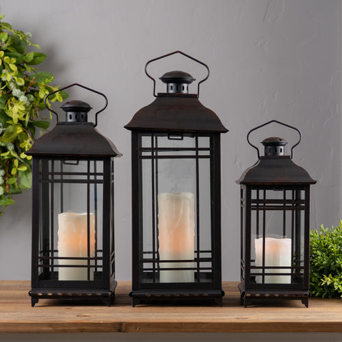 Set of 3 red metal lanterns with glass panels displayed with lit candles inside, festive farmhouse and holiday décor