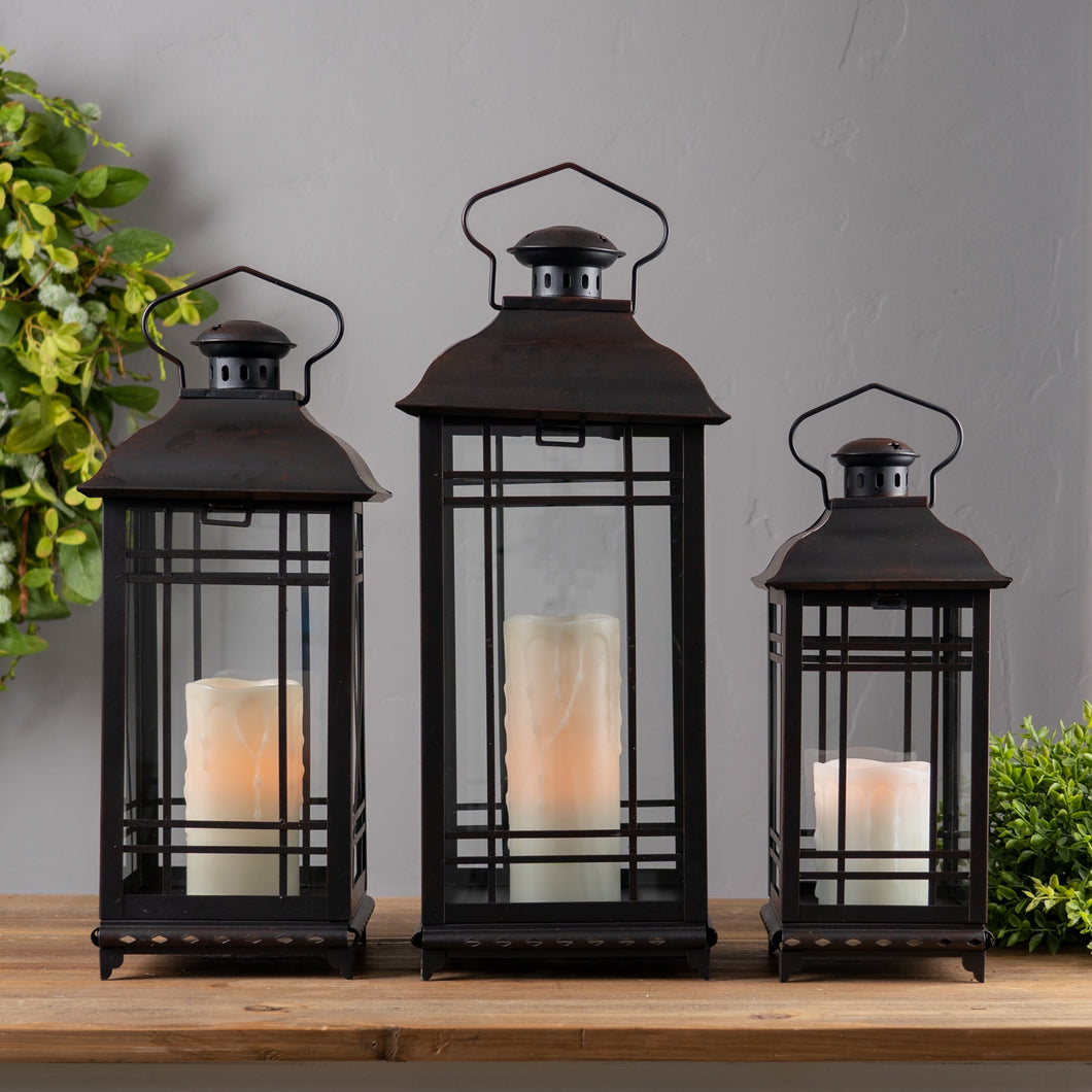 Set of 3 red metal lanterns with glass panels displayed with lit candles inside, festive farmhouse and holiday décor