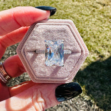 Load image into Gallery viewer, Hexagonal pink velvet box with Valentina  ring held by a hand outdoors.
