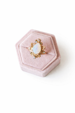 Load image into Gallery viewer, Gold ring with a large opal gemstone in a pink hexagonal jewelry box on a white background
