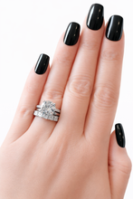 Load image into Gallery viewer, Hand with black nail polish wearing a stack of 3 silver rings on a white background
