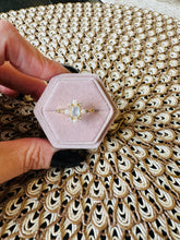 Load image into Gallery viewer, Hexagonal pink jewelry box with a gold ring on a textured surface
