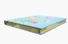 Load image into Gallery viewer, Floral-patterned journal with gold binding on a white background
