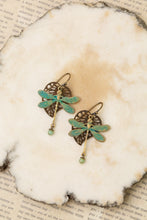 Load image into Gallery viewer, Dragonfly and leaf earrings on a textured white surface with text underneath
