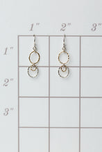 Load image into Gallery viewer, Gold hoop earrings on a grid for size reference
