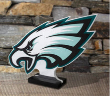 Load image into Gallery viewer, Philadelphia Eagles logo on a stand against a stone wall background
