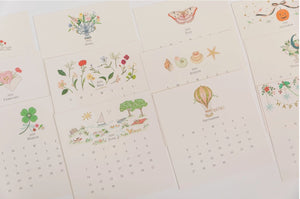 Karen Adams 2026 Desk Calendar monthly cards with foil details and illustrated artwork