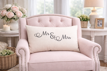 Load image into Gallery viewer, Pink armchair with a 'Mr &amp; Mrs' pillow in a decorated room.
