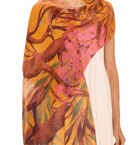 "Model wearing oriental crane ochre scarf made from linen and cotton blend, styled as a lightweight wrap"