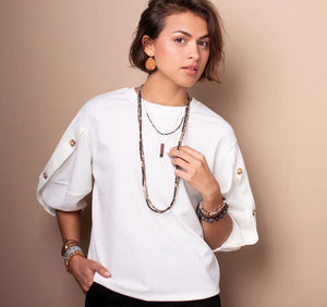 Woman wearing stone wrap as necklace and bracelets