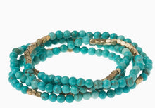 Load image into Gallery viewer, Close-up of semi-precious turquoise beads with gold accents
